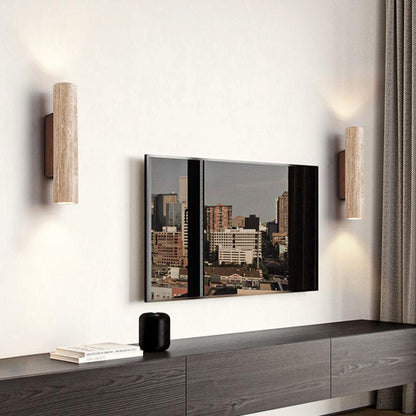 Travertine wall lights positioned beside a wall picture