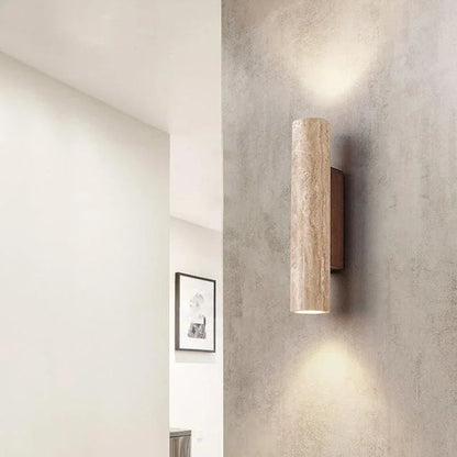 Travertine cylinder wall light on a textured wall