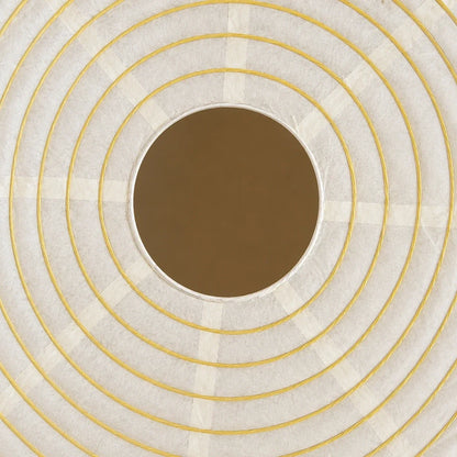 Close-up detail of a Japanese paper globe pendant light, showcasing the textured white paper shade with concentric yellow wire rings and a central opening.