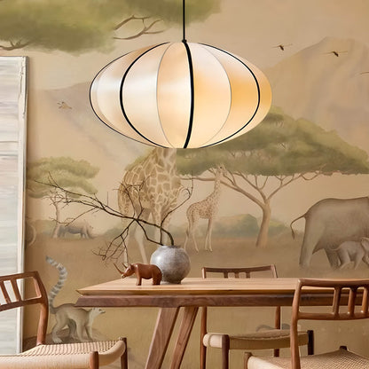 Rounded satin fabric lantern pendant light above a dining table