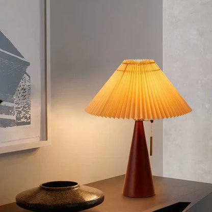 Walnut-finish wooden table lamp on a sideboard