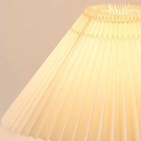 Close-up of illuminated pleated fabric lampshade