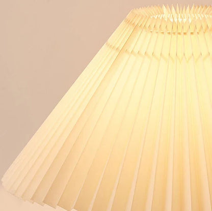 Close-up of illuminated pleated fabric lampshade