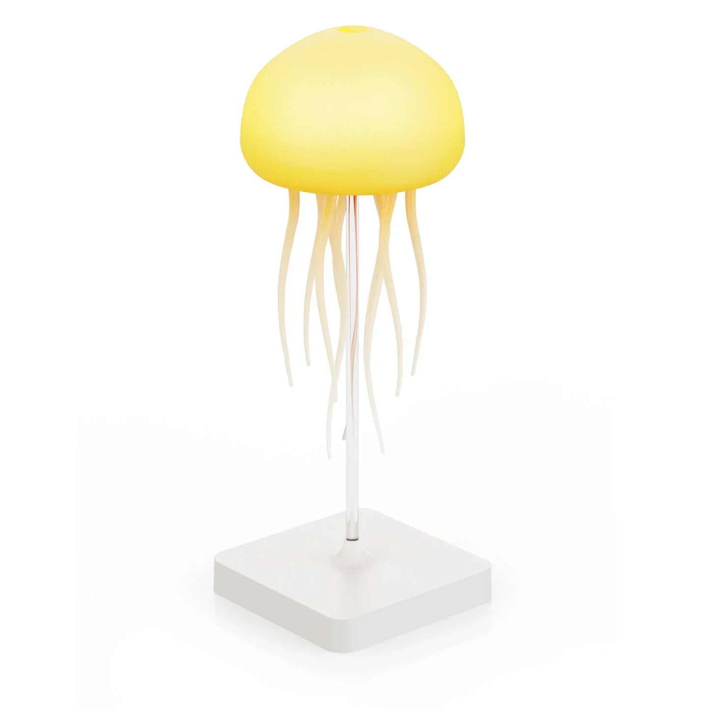 A jellyfish-shaped LED table lamp with a glowing yellow dome and hanging tentacles, mounted on a clear stand with a white square base.