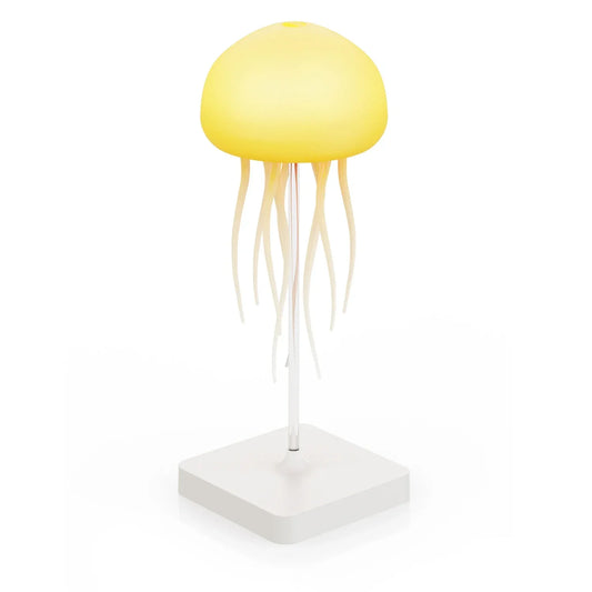 A jellyfish-shaped LED table lamp with a glowing yellow dome and hanging tentacles, mounted on a clear stand with a white square base.