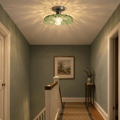 Textured glass ceiling light casting a pattern over a landing