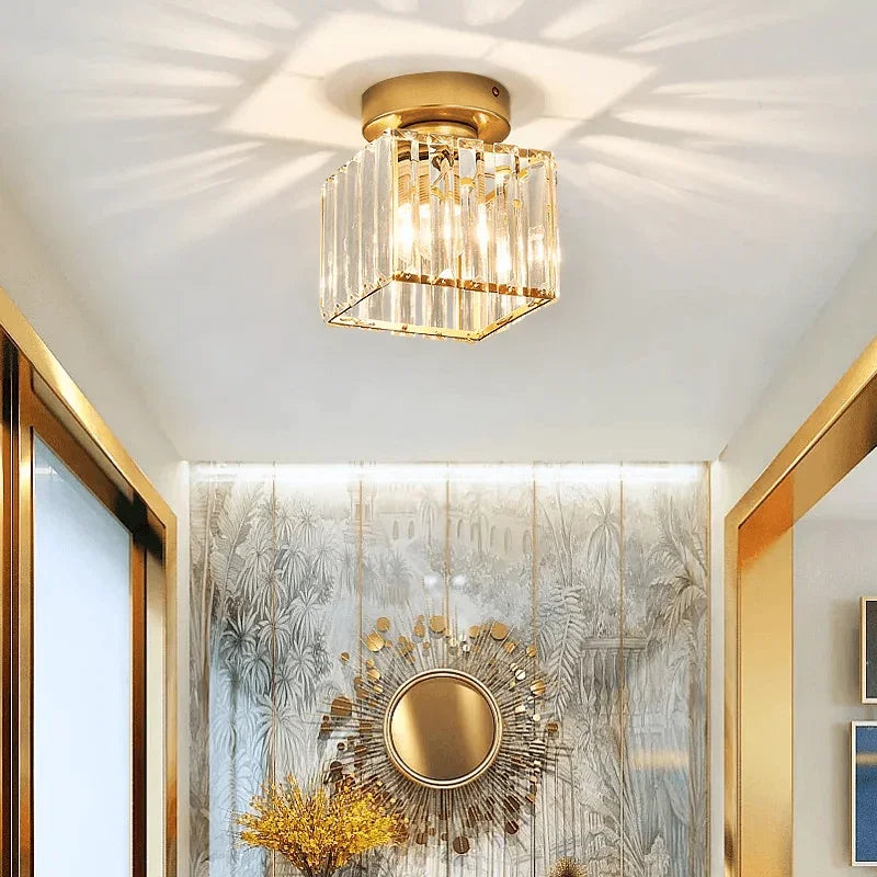 Gold square crystal ceiling fitting above an entrance