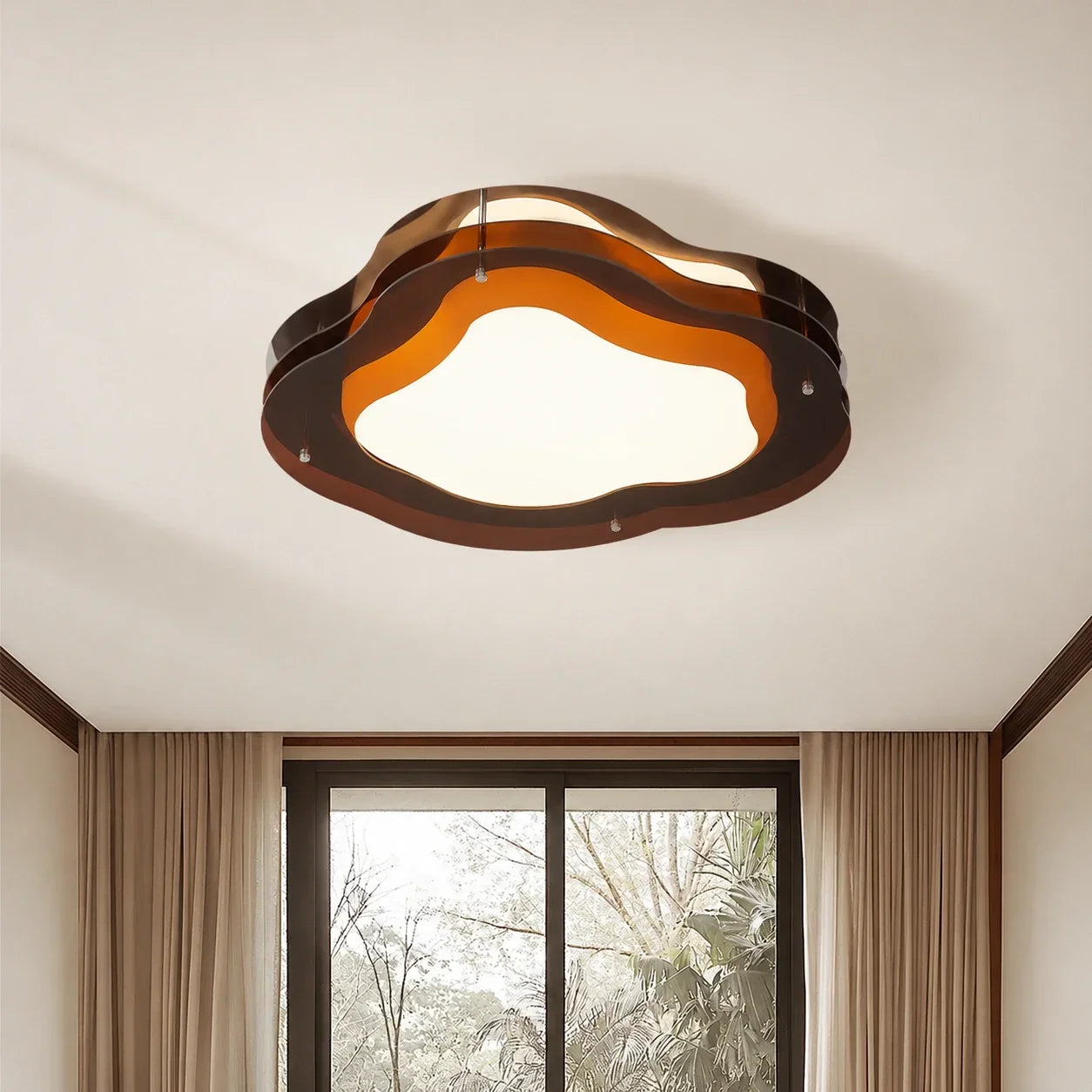A modern cloud-shaped flush mount LED ceiling light with layered brown wavy panels, illuminated on a white ceiling in a contemporary room.