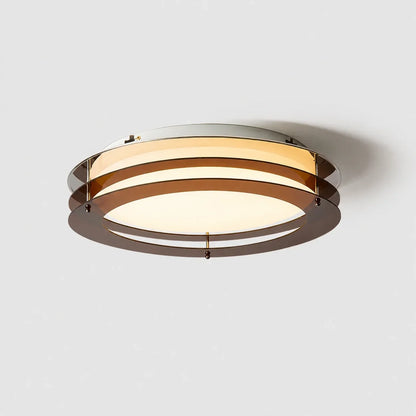 A modern circular layered LED ceiling light featuring translucent amber rings and a warm glowing flush mount diffuser, shown against a white background.