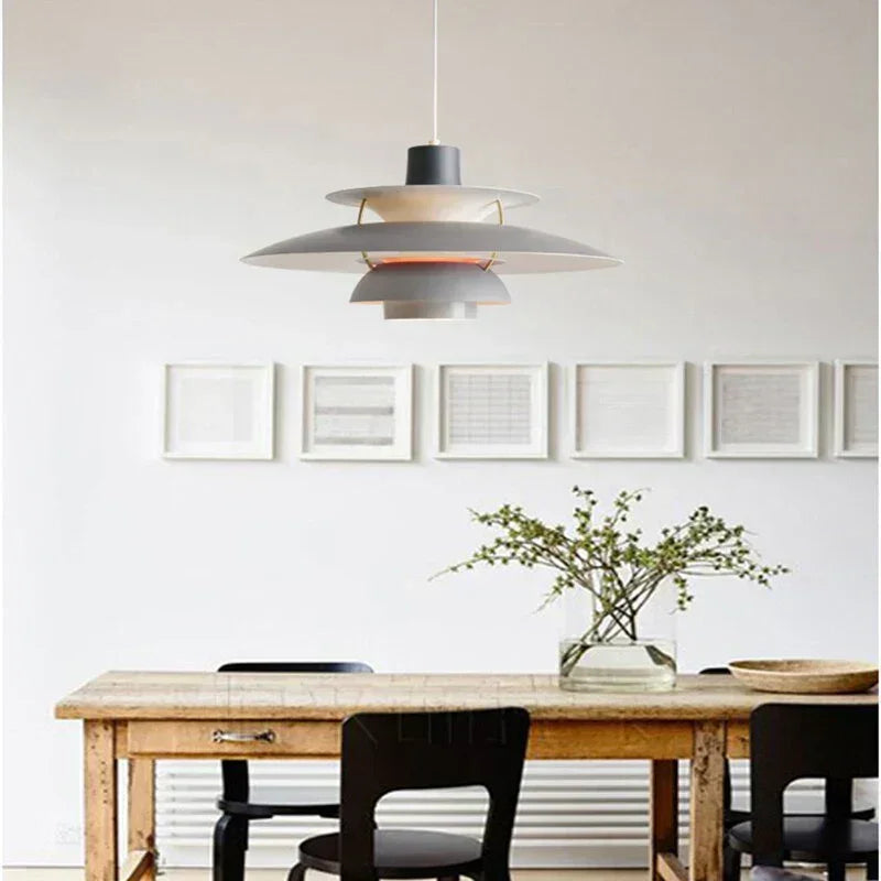 Layered metal pendant above a dining table