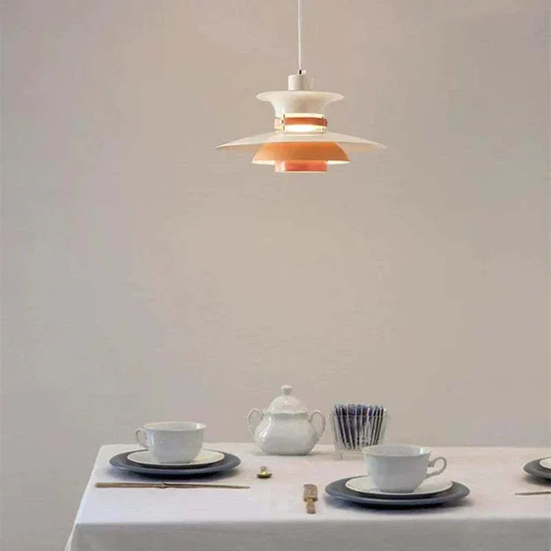 Orange and white pendant above a dining table