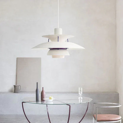 White and purple pendant above a glass dining table