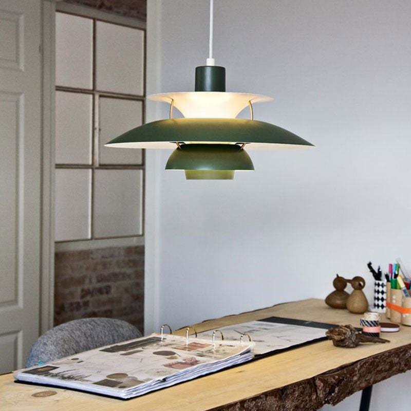 Green layered metal pendant above a table