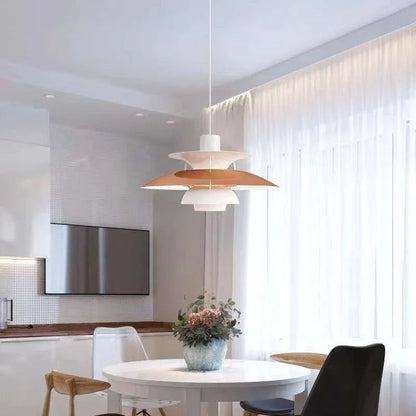 Orange and white layered pendant above a dining table