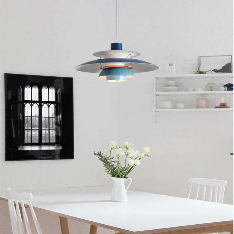 Blue layered pendant above a white dining table
