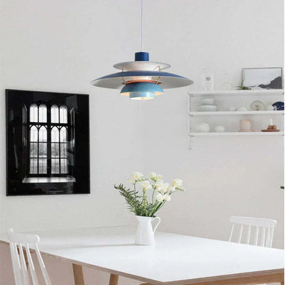 Blue layered pendant above a white dining table