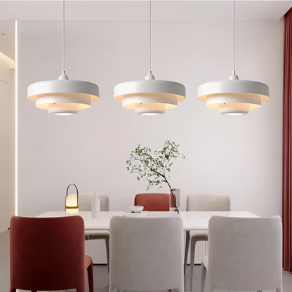White layered pendants above a dining table