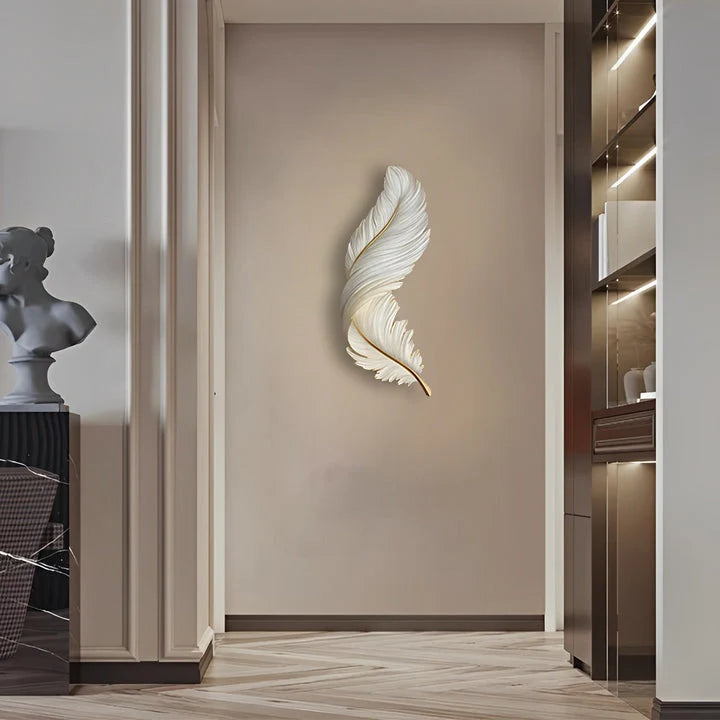 A vertical white LED feather wall lamp mounted on a neutral interior wall, providing soft ambient lighting in a modern hallway setting.