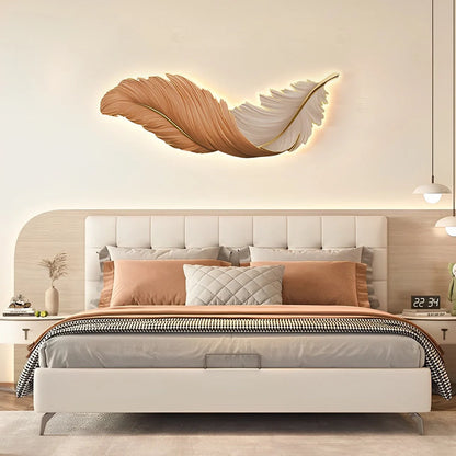 Horizontal orange and white LED feather wall lamp mounted above a modern bedroom bed, providing warm ambient lighting for a stylish interior.