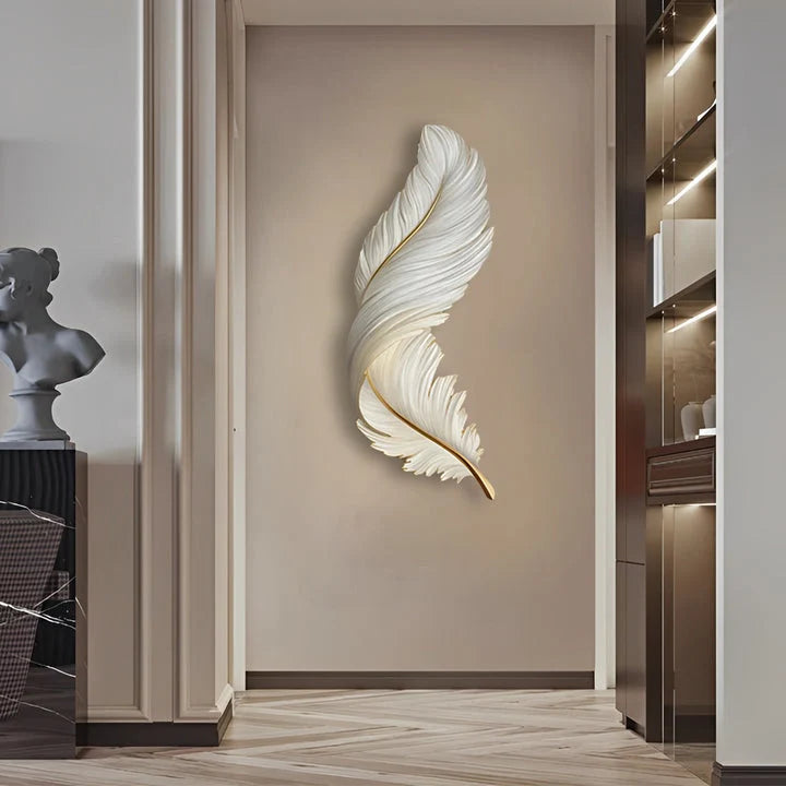 Vertical white feather-shaped LED wall lamp mounted on a beige hallway wall, providing elegant ambient lighting for a modern interior design scheme.