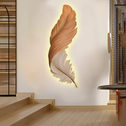 Vertical orange and white LED feather wall lamp mounted in a modern hallway, providing warm ambient backlighting to create a decorative focal point.