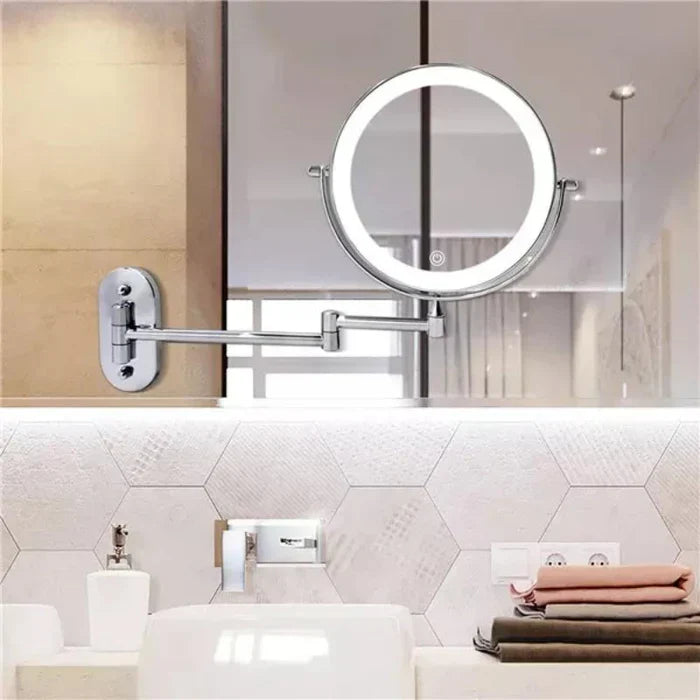 Silver LED magnifying wall mirror above a bathroom basin