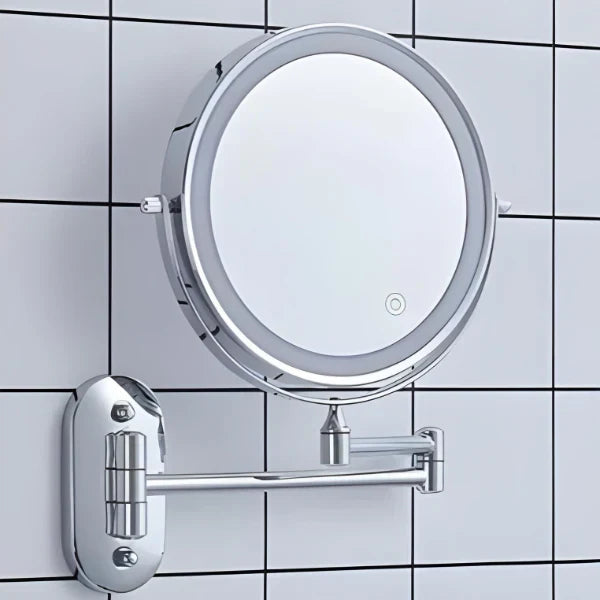 Silver LED magnifying wall mirror against bathroom tiles