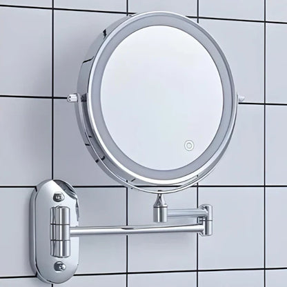Silver LED magnifying wall mirror against bathroom tiles