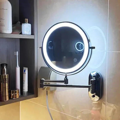 Silver LED magnifying wall mirror connected to a charging cable