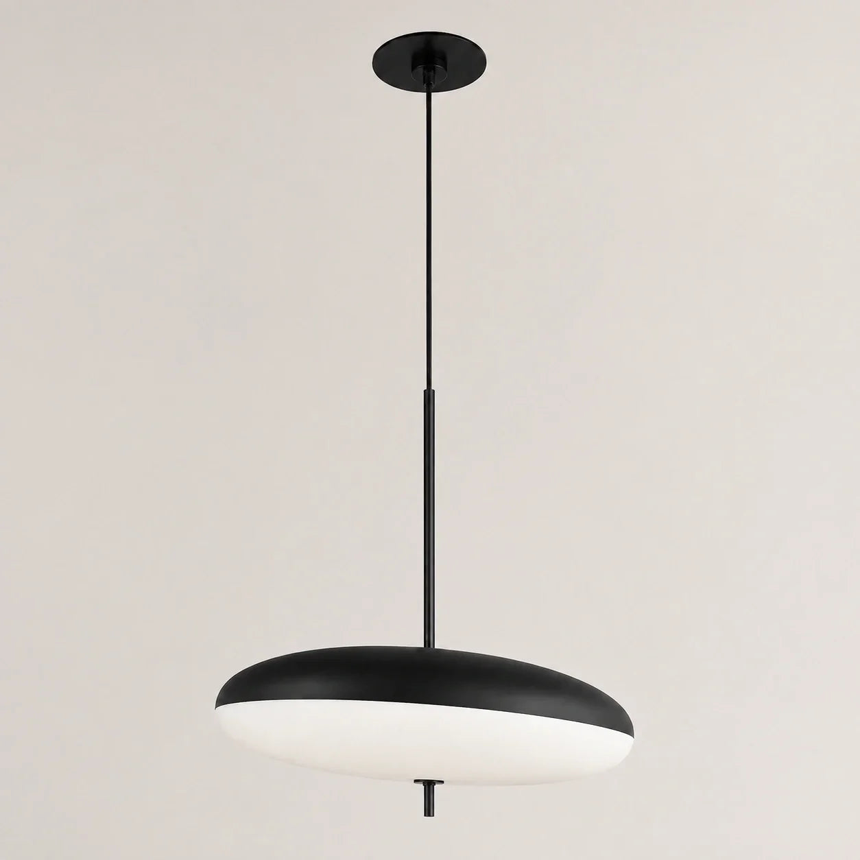 Modern LED pendant light featuring a sleek black and white flying saucer design, suspended by a slim black rod, ideal for contemporary dining rooms.