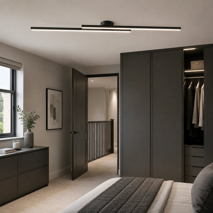 A modern linear ceiling light fixture with a black frame and dual horizontal light bars, mounted on a white ceiling in a contemporary bedroom setting.