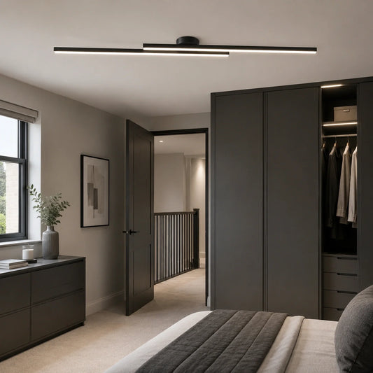 A modern linear ceiling light fixture with a black frame and dual horizontal light bars, mounted on a white ceiling in a contemporary bedroom setting.