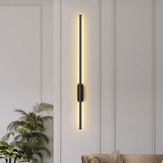 Long black LED wall light beside a sofa