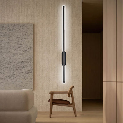 Cool white linear wall light beside a chair