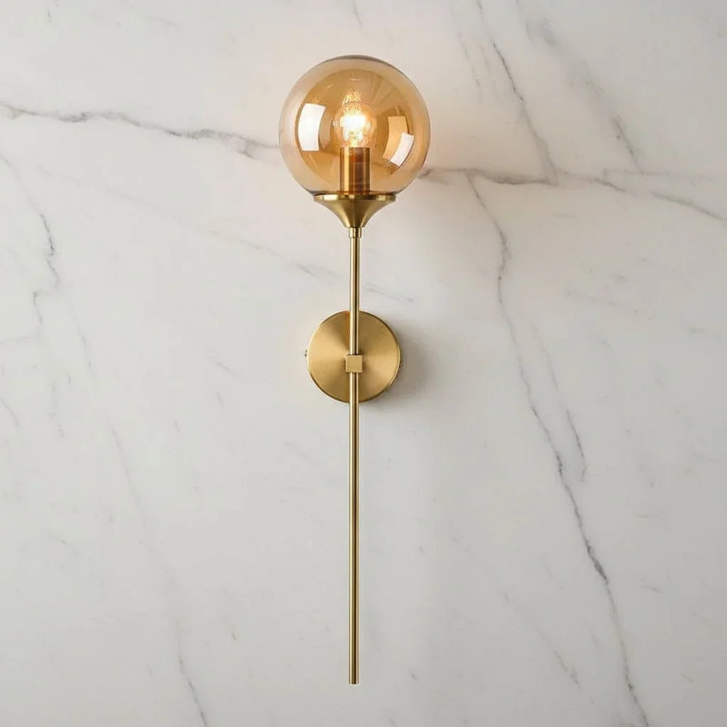 Amber glass globe wall light with long brass stem