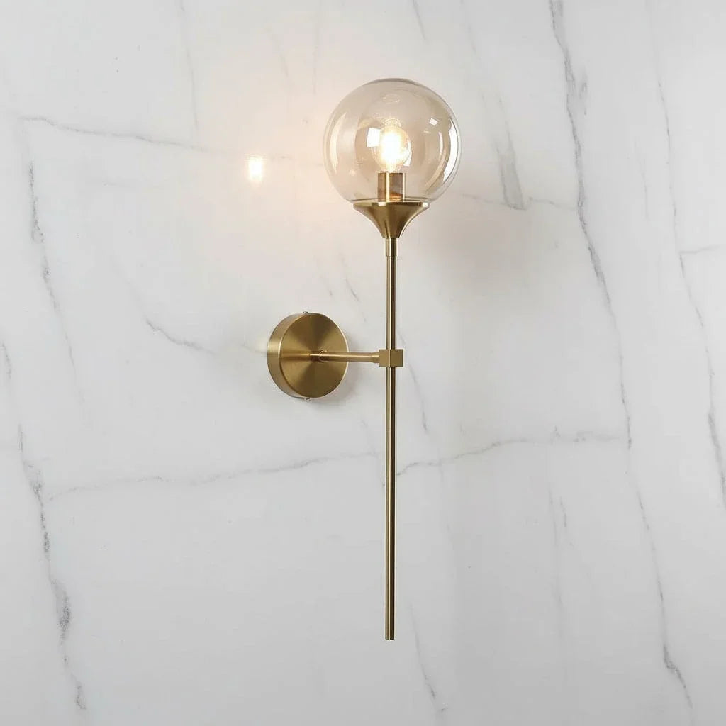 Clear glass globe wall light with long brass stem