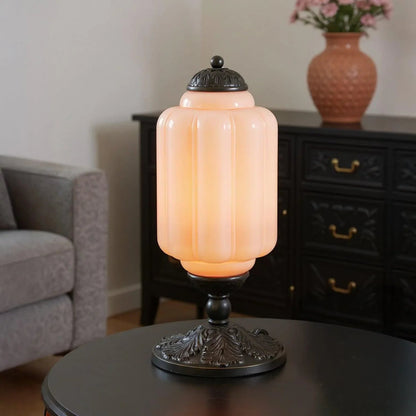 Glowing pink glass table lamp with black base