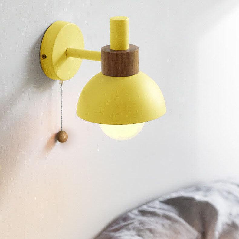 Lemon yellow globe wall light on a white wall