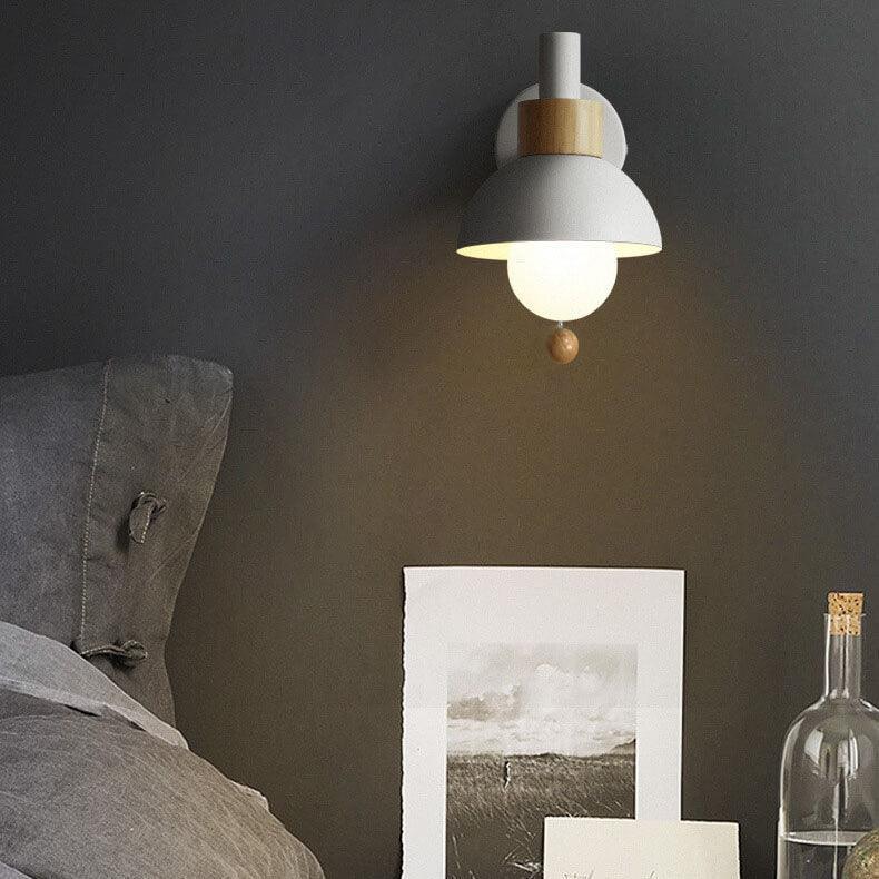 White globe wall light on a dark bedroom wall