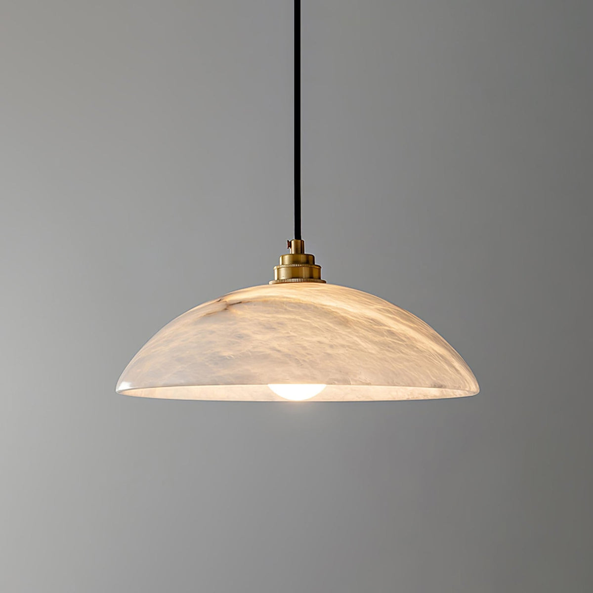 Illuminated marble dome pendant viewed from the side