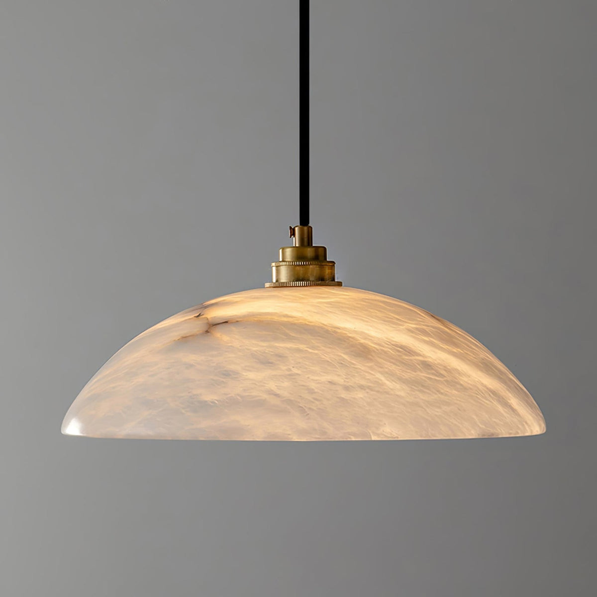 Close-up of glowing marble shade and copper fitting