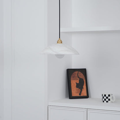 White marble pendant in a room with framed artwork