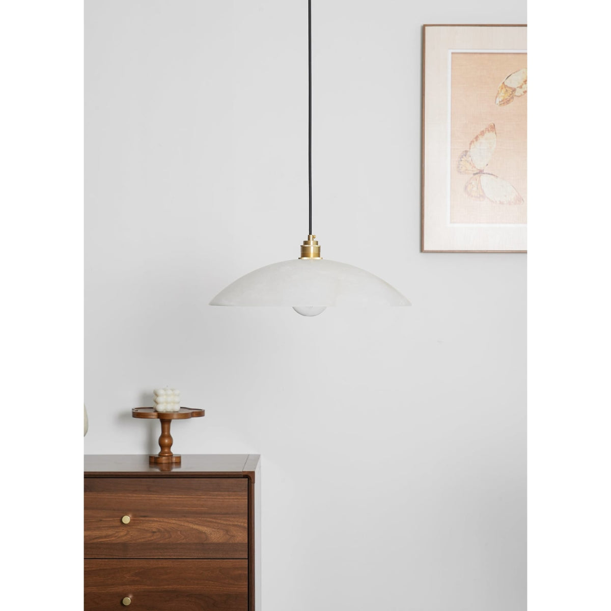 White marble pendant above a timber cabinet