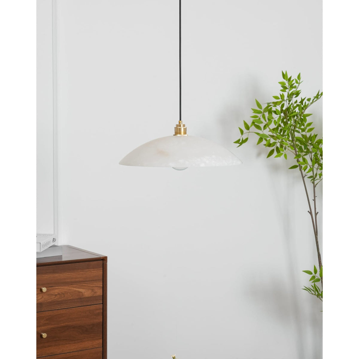 Marble pendant beside green foliage