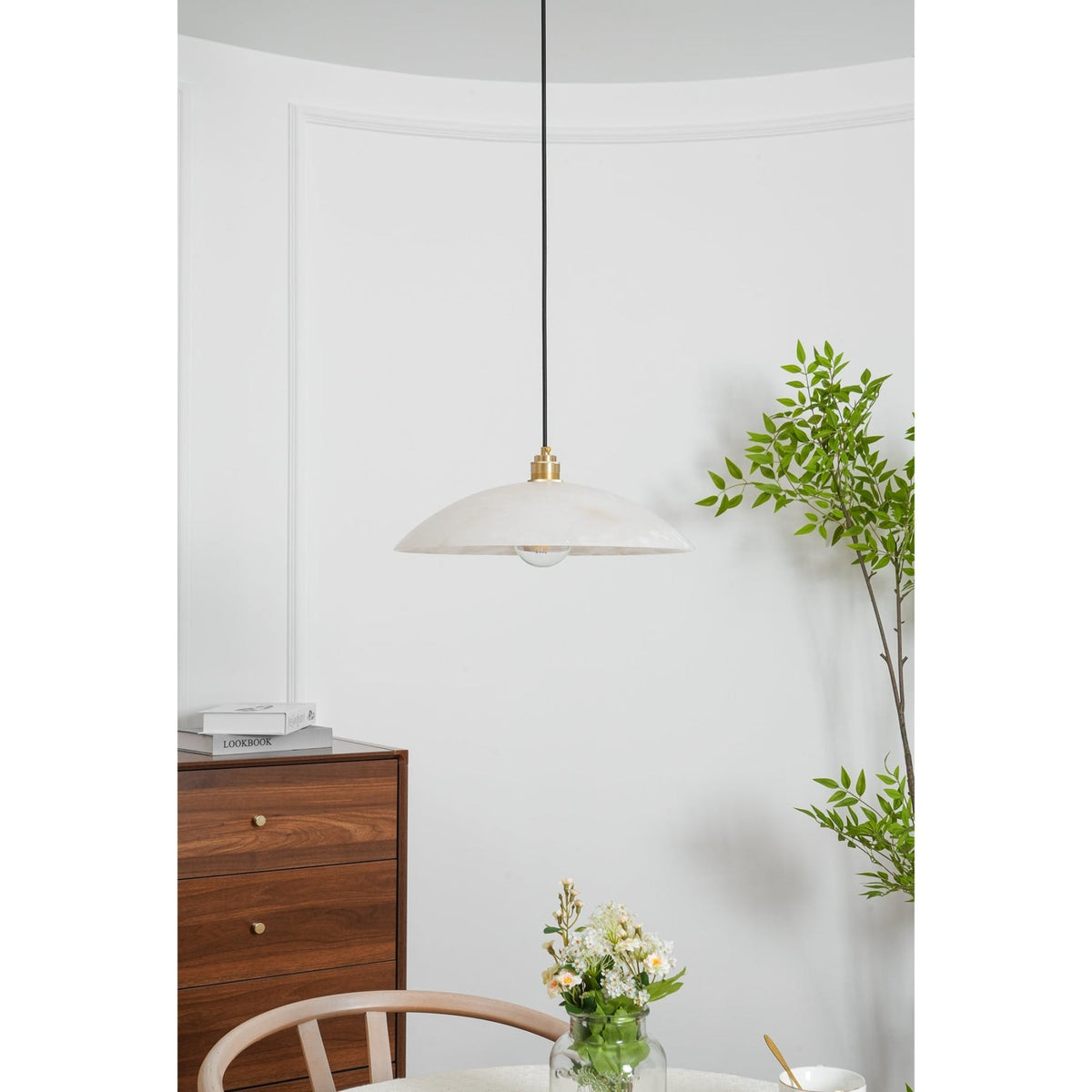 Marble pendant above a chair and cabinet
