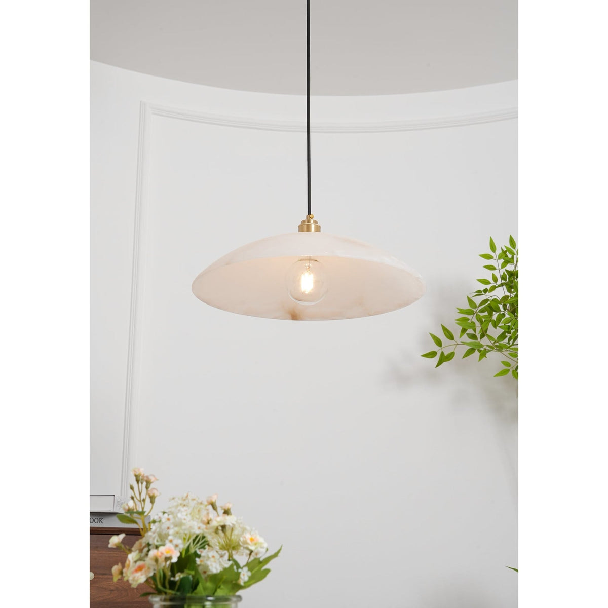 Illuminated bulb beneath a marble dome shade