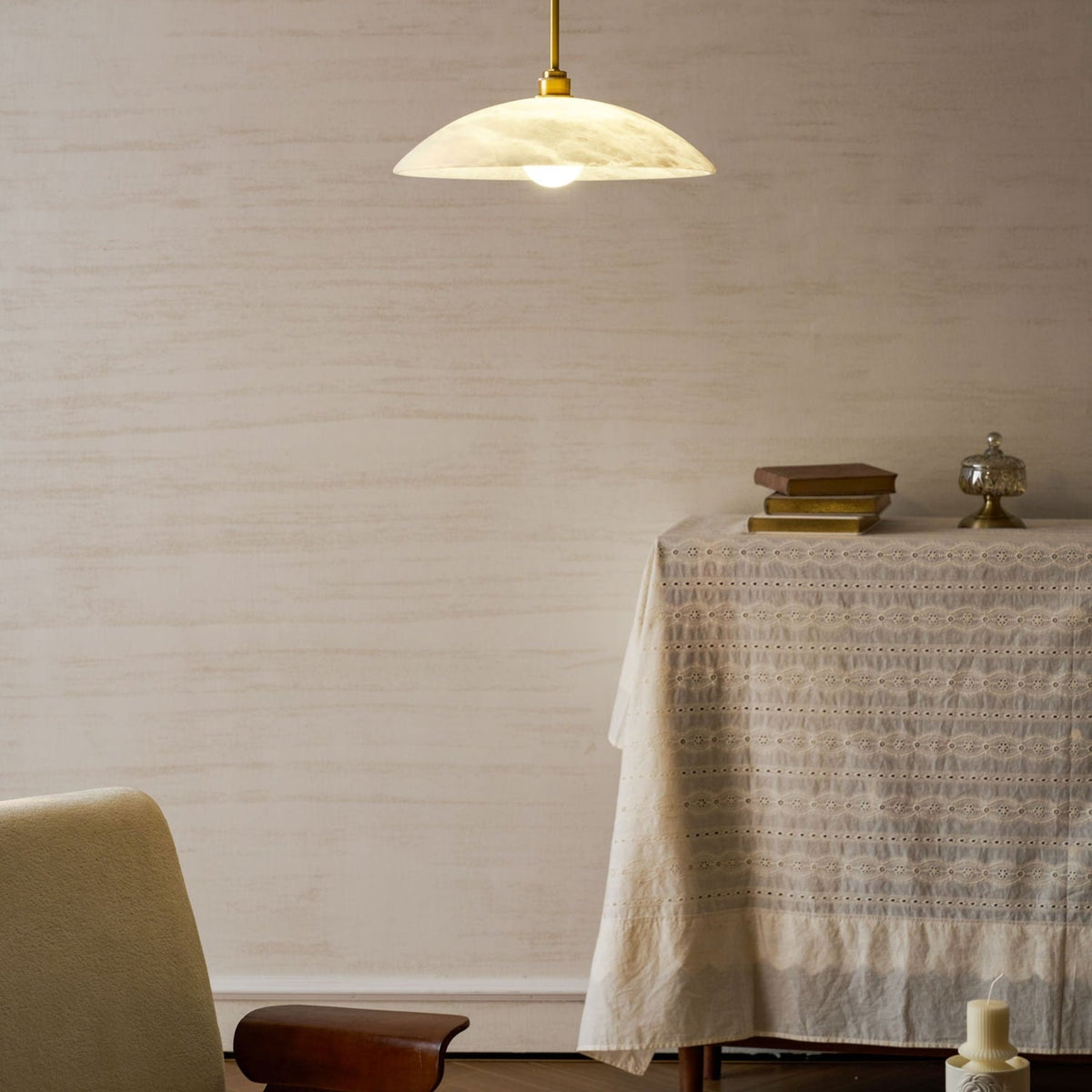 Illuminated marble pendant beside a cloth-covered table