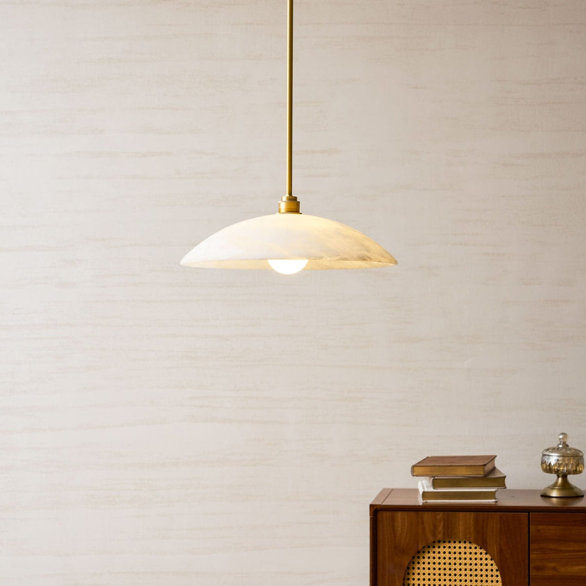 Marble pendant above a cabinet and books