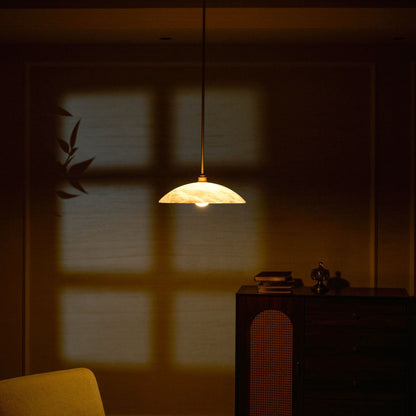 Marble dome pendant glowing in a darkened room