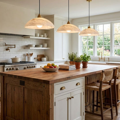 Three marble dome pendants above a timber kitchen island